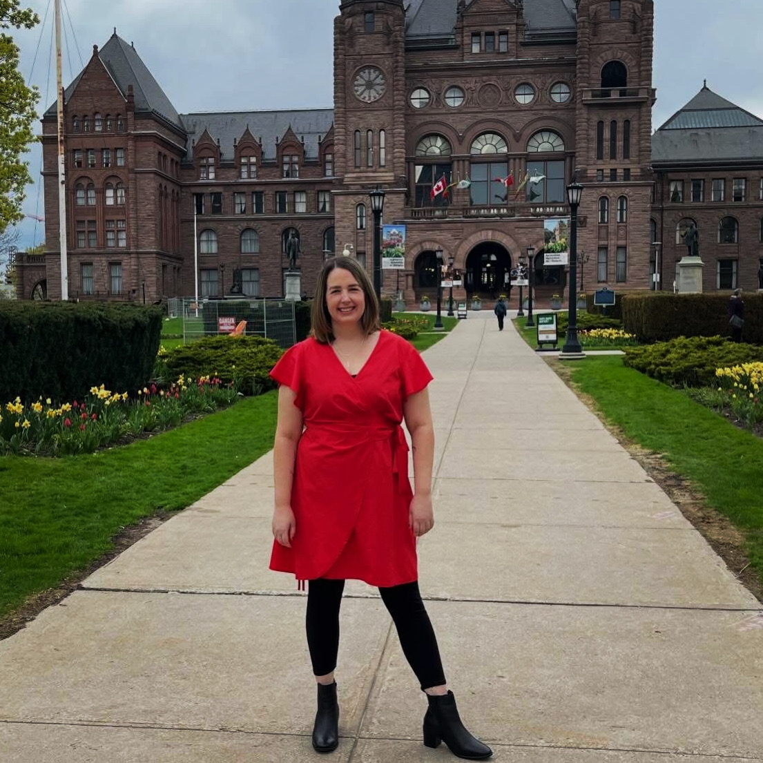 Shannon McNally standing outside the Ontario Legislative Building at Queen's Park